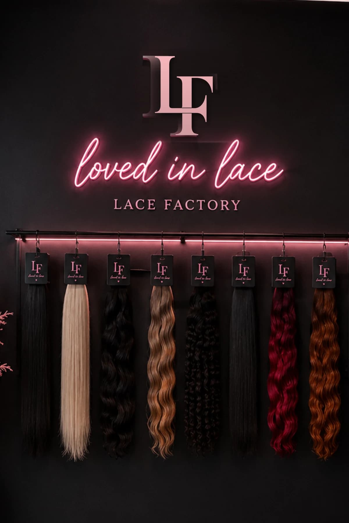 The Lace Factory Miami showroom wall — every texture hung by length beneath the neon